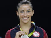 FILE - In this Aug. 16, 2016, file photo, United States’ Aly Raisman shows off her silver medal after the artistic gymnastics women’s apparatus final at the 2016 Summer Olympics in Rio de Janeiro, Brazil. Six-time Olympic medal winning gymnast Aly Raisman says she is among the young women abused by a former USA Gymnastics team doctor. Raisman tells “60 Minutes” she was 15 when she was first treated by Dr. Larry Nassar, who spent more than two decades working with athletes at USA Gymnastics but now is in jail in Michigan awaiting sentencing after pleading guilty to possession of child pornography.