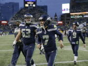 Seattle Seahawks kicker Blair Walsh (7) and offensive guard Mark Glowinski (63) walk off the field after an NFL football game against the Washington Redskins, Sunday, Nov. 5, 2017, in Seattle. Walsh missed on three field goal attempts and the Redskins won 17-14.