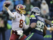 Washington Redskins quarterback Kirk Cousins passes under pressure from Seattle Seahawks defensive end Dwight Freeney (93) in the second half of an NFL football game, Sunday, Nov. 5, 2017, in Seattle.