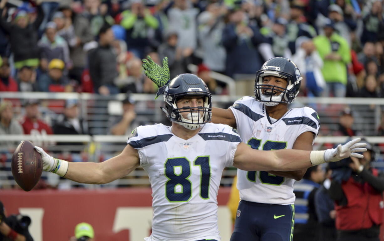 Seattle Seahawks tight end Nick Vannett (81) celebrate his touchdown reception with teammate Tyler Lockett during the second half of an NFL football game against the San Francisco 49ers Sunday, Nov. 26, 2017, in Santa Clara, Calif.