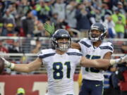 Seattle Seahawks tight end Nick Vannett (81) celebrate his touchdown reception with teammate Tyler Lockett during the second half of an NFL football game against the San Francisco 49ers Sunday, Nov. 26, 2017, in Santa Clara, Calif.