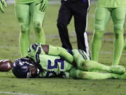 Seattle Seahawks cornerback Richard Sherman (25) lies injured on the turf after tackling Arizona Cardinals wide receiver John Brown (12) during the second half of an NFL football game, Thursday, Nov. 9, 2017, in Glendale, Ariz. Sherman did not return to the game after the injury.