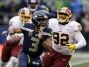 FILE - In this Sunday, Nov. 5, 2017, file photo, Seattle Seahawks quarterback Russell Wilson (3) scrambles away from Washington Redskins defensive end Stacy McGee (92) in the second half of an NFL football game in Seattle. The Seahawks are favored again when they face the Arizona Cardinals on Thursday night.