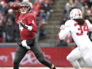 Washington State quarterback Luke Falk (4) throws a pass as he is chased by Stanford linebacker Peter Kalambayi (34) during the first half of an NCAA college football game in Pullman, Wash., Saturday, Nov. 4, 2017.