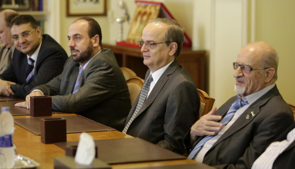 Members of the Syrian Coalition, Syria’s main political opposition group, Haitham al-Maleh, right, Hadi Bahra, the head of the coalition, second right, and Nasr al-Hariri, Secretary-General of the SNC, meet with Arab League Secretary-General Nabil Elaraby at the league’s headquarters in Cairo, Egypt, in 2014. Syria’s opposition is gathering in Saudi Arabia hoping to close ranks ahead of new negotiations starting Wednesday, Nov. 22, 2017, but they are a house divided in ways that enhance Syrian President Bashar Assad’s upper hand. Hours before the meeting, a dozen opposition figures resigned.