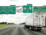 Traffic moves along Interstate 4 near Walt Disney World in Orlando, Fla. VisitOrlando.com has travel specials online through Tuesday.