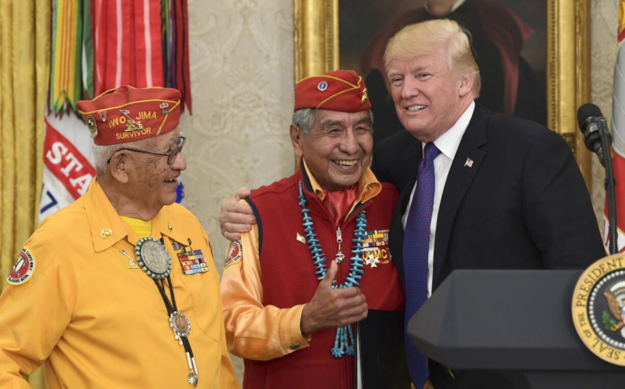 President Donald Trump, right, meets with Navajo Code Talkers Peter MacDonald, center, and Thomas Begay, left, in the Oval Office of the White House in Washington on Monday.