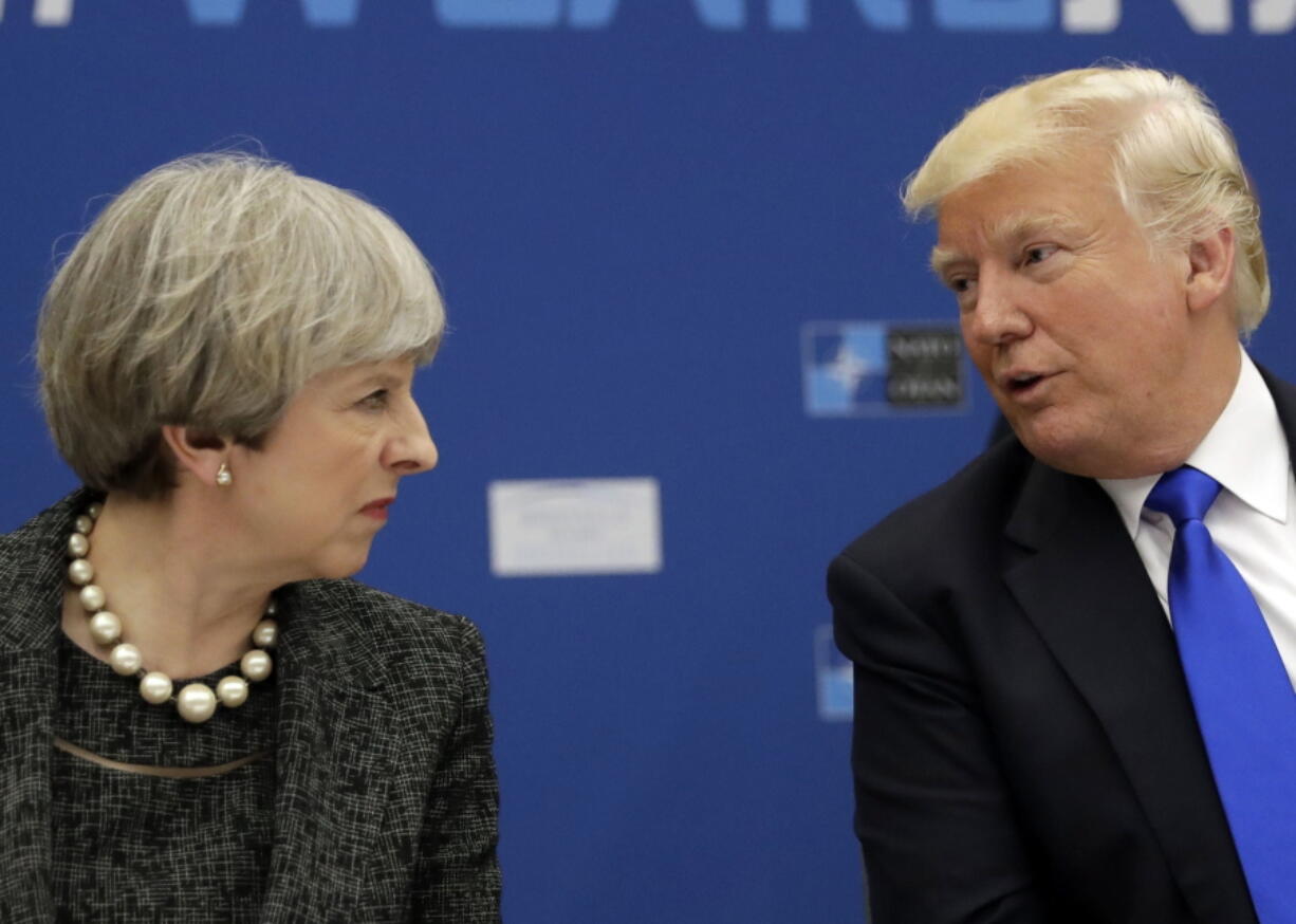 FILE - In this May 25, 2017, file photo, U.S. President Donald Trump, right, speaks to British Prime Minister Theresa May during in a working dinner meeting at the NATO headquarters during a NATO summit of heads of state and government in Brussels. Trump initially responded to May’Äôs criticism of his retweeting of inflammatory anti-Muslim videos from a fringe British political group by directing his message to the wrong Theresa May on Twitter Nov. 29, 2017 .