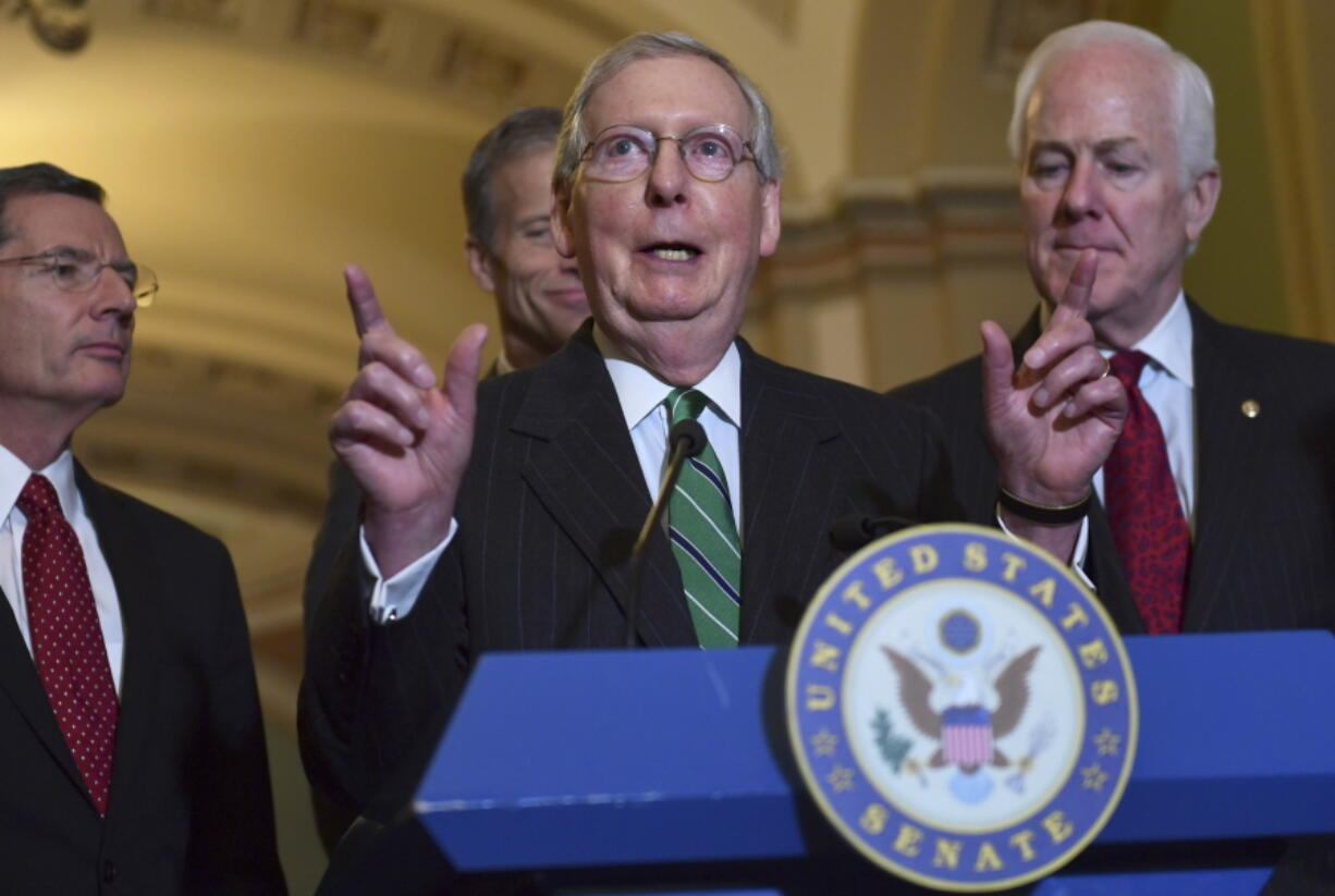 Senate Majority Leader Mitch McConnell of Ky., second from right, speaks to reporters following the weekly Republican policy luncheon on Capitol Hill in Washington, Tuesday, Oct. 31, 2017. Joining McConnell are from left, Sen. John Barrasso, R-Wyo., Sen. John Thune, R-S.D., and Sen. John Cornyn, R-Texas.