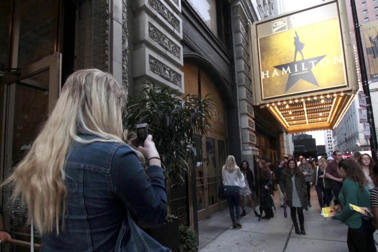 Alex Richards takes a photo of Meera Ganesh outside the CIBC Theatre after watching “Hamilton: An American Musical” in Chicago. They were among the approximately 2,000 first year students at Northwestern University who got to see the show for free as part of the school’s “One Book One Northwestern” program. It’s one of the ways colleges are using the hugely popular musical to teach students about history, art, critical thinking, performance, culture, and even politics.