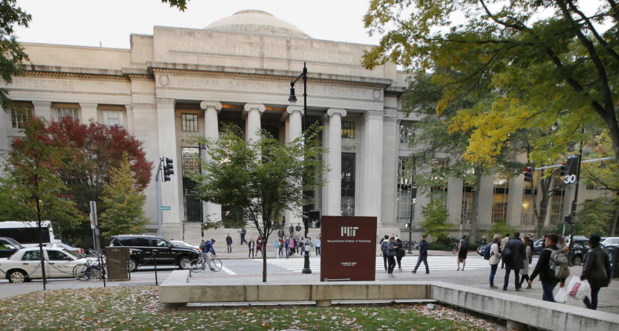 Students walk on the Massachusetts Institute of Technology campus in Cambridge, Mass. The state’s Supreme Judicial Court will hear arguments Tuesday in a lawsuit filed against MIT by the family of graduate student Han Nguyen, who killed himself in 2009. The family claims his death was preventable and that the school had a legal duty to act with reasonable care to protect him from harm. The school said it can’t be blamed for his death. MIT and 18 other universities are urging the court to reject the family’s case.