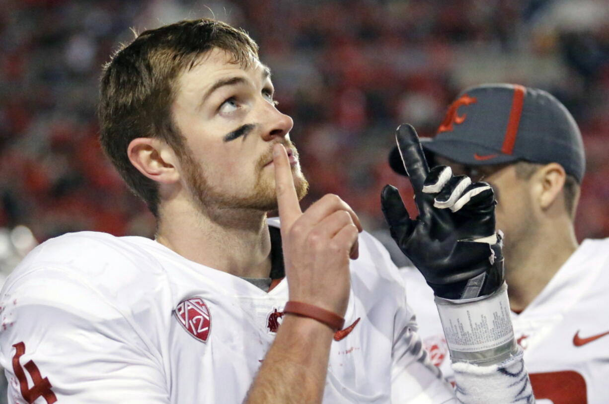 Washington State quarterback Luke Falk (4) points skyward after throwing a touchdown against Utah in the second half during an NCAA college football game, Saturday, Nov. 11, 2017, in Salt Lake City.