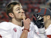 Washington State quarterback Luke Falk (4) points skyward after throwing a touchdown against Utah in the second half during an NCAA college football game, Saturday, Nov. 11, 2017, in Salt Lake City.