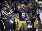 Washington running back Myles Gaskin (9) stands in the end zone after he scored his first touchdown in the first half of an NCAA college football game against Washington State, Saturday, Nov. 25, 2017, in Seattle. (AP Photo/Ted S.