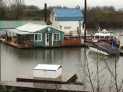 Firefighters from Clark County Fire & Rescue extinguished an attic fire at a floating home Tuesday at a marina in Ridgefield.