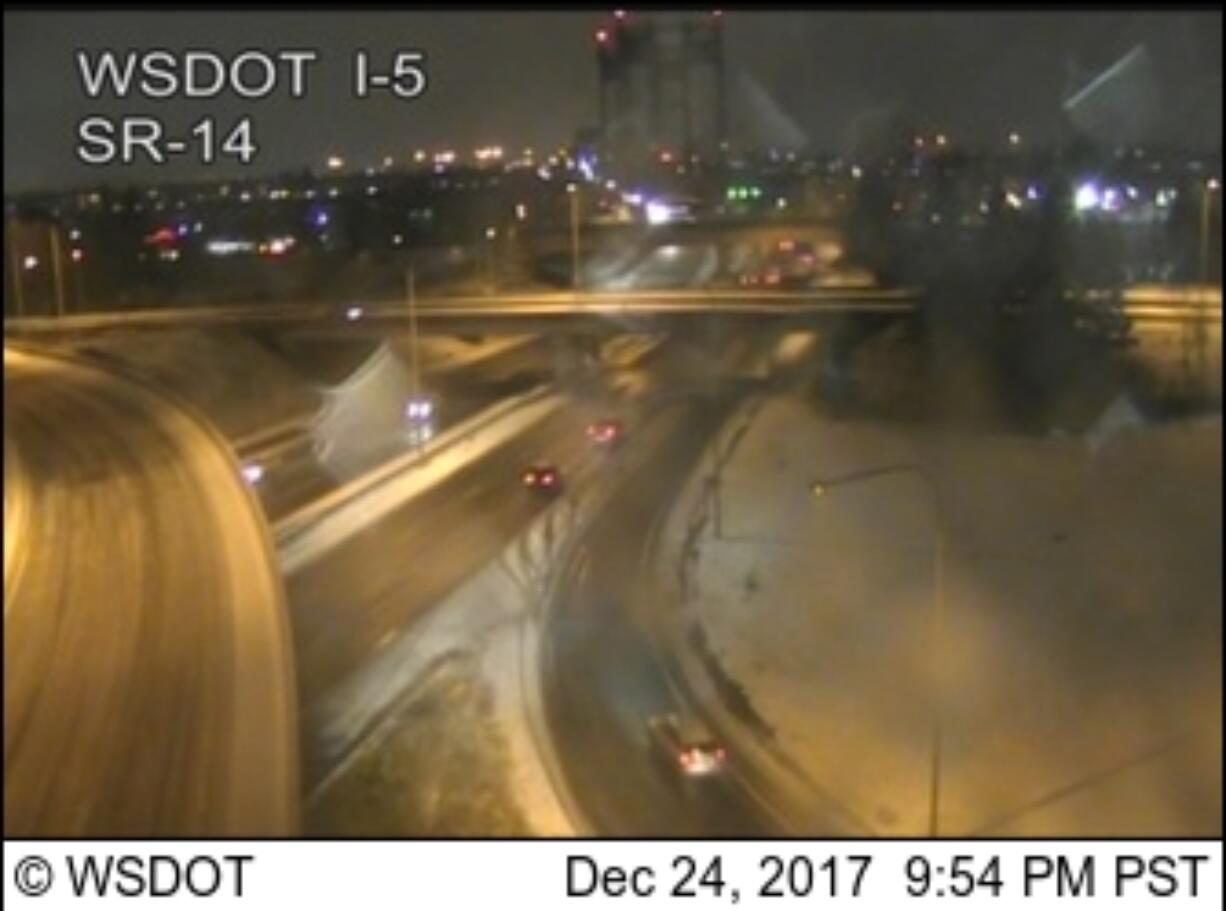 Traffic approaches the southbound span of the Interstate 5 Bridge on a snowy, icy Christmas Eve.