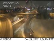 Traffic approaches the southbound span of the Interstate 5 Bridge on a snowy, icy Christmas Eve.