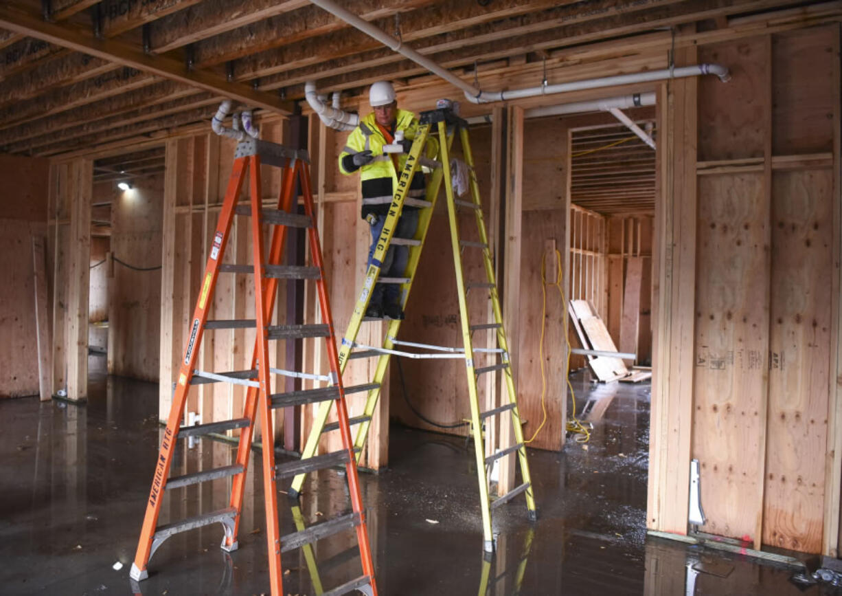 Plumbing foreman Steve Beskow installs pipes in November at Meriwether Place on Fourth Plain Boulevard. The 30-unit complex will be one of the first completed projects using Affordable Housing Fund money.