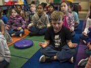 Carter Griffin closes his eyes during a mindfulness exercise after recess in Katrina Munro’s first-grade classroom at Illahee Elementary School earlier this month. Evergreen Public Schools classrooms are incorporating mindful meditation into their day-to-day activities. The goal is to get students conscious of their thinking and behavior, calm and focused, and less stressed in the classroom.