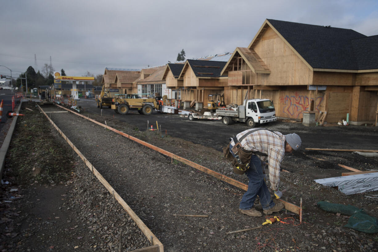 Mario Basquez of Colf Construction lends a hand to the construction at the Minit Mart in the Fruit Valley neighborhood on Nov. 27.