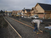 Mario Basquez of Colf Construction lends a hand to the construction at the Minit Mart in the Fruit Valley neighborhood on Nov. 27.