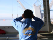 Ivan Barte, second mate aboard the MV Crest Navigator, looks at the Port of Vancouver terminal while docked in early December.