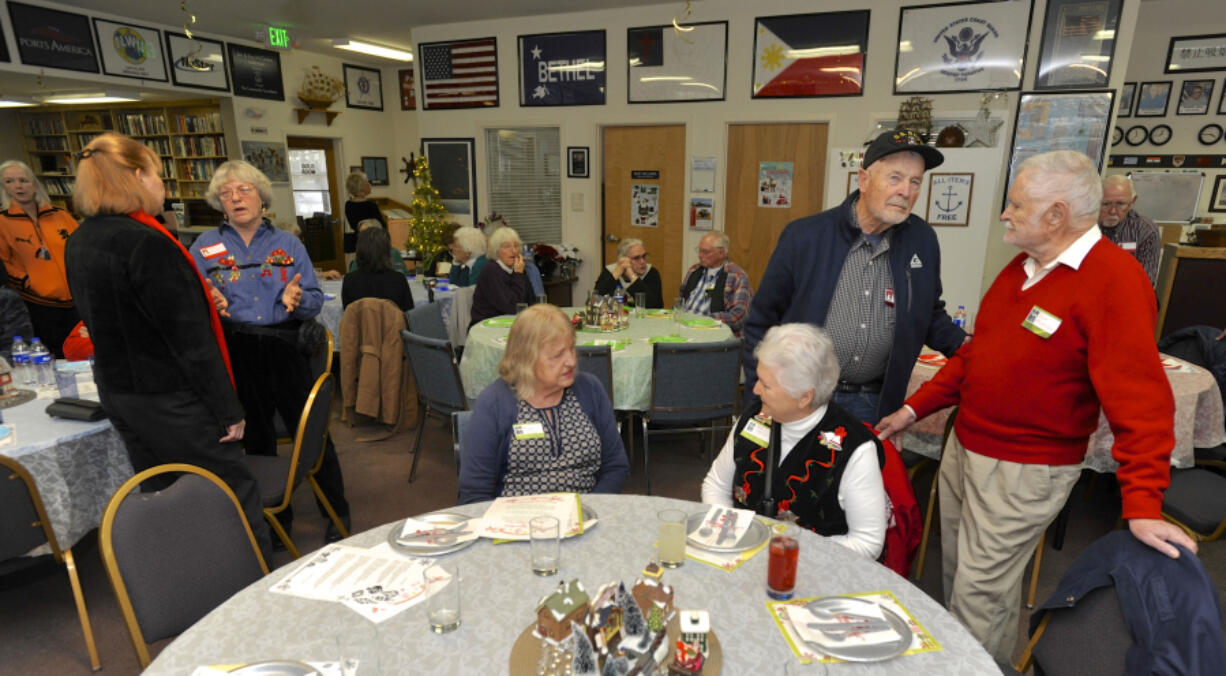 Guests talk during a Christmas party hosted by the Fort Vancouver Seafarers Center at the Port of Vancouver. The volunteer-driven center is often one of the few places thousands of foreign ship workers visit when they dock at the Port of Vancouver.