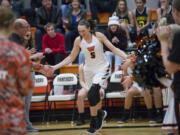 Washougal's Beyonce Bea high-fives her teammates before the first game of the season against Evergreen High School at Washougal High School, Monday November 27, 2017.