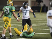 Hockinson's Aidan Mallory (1) celebrates a tackle against Tumwater's Jakob Holbrook (22) during the 2A State Football Championship game Saturday, Dec. 2, 2017, in Tacoma, Wash.