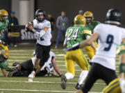 Hockinson's Canon Racanelli (12) looks for an open receiver during the 2A state football championship game against Tumwater on Saturday, Dec. 2, 2017, in Tacoma, Wash.