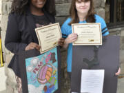 Washougal: Jemtegaard Middle School art students, from left, Kabiah Blain and Jaedyn Burrese were honored by district staff for their work, which has been hanging in the district office.