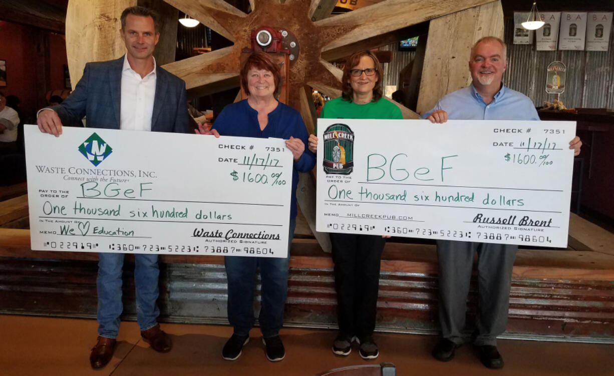 Battle Ground: Jason Hudson, regional vice president with Waste Connections, from left, Battle Ground Education Foundation’s Marcia Christian and Colleen O’Neal, and Russell Brent with Mill Creek Pub celebrate the restaurant’s sixth anniversary by donating to the foundation.