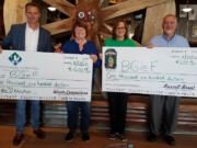 Battle Ground: Jason Hudson, regional vice president with Waste Connections, from left, Battle Ground Education Foundation’s Marcia Christian and Colleen O’Neal, and Russell Brent with Mill Creek Pub celebrate the restaurant’s sixth anniversary by donating to the foundation.