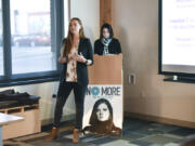 WSU Vancouver student Kelsie Reef, left, presents her team’s campaign to a group of judges and WSU Vancouver students Tuesday during the Washington Says No More campaign presentations, while her teammate Melanie Shelton prepares at the lectern behind her at Pacific Continental Bank in Vancouver.