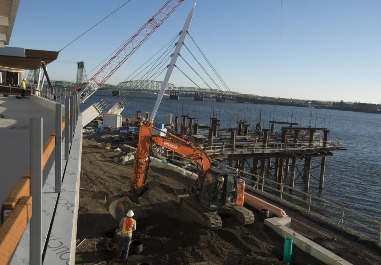 The Grant Street Pier at The Waterfront Vancouver is starting to take shape as construction crews attach the pier cables Thursday. Two restaurant buildings and the pier are on pace to open in July, officials said.