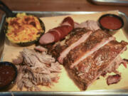 The Smoke Stack plate, which includes macaroni and cheese, left, smoked sausage, sliced brisket and spare ribs is pictured at The Smokin Oak in downtown Vancouver, Thursday December 14, 2017.