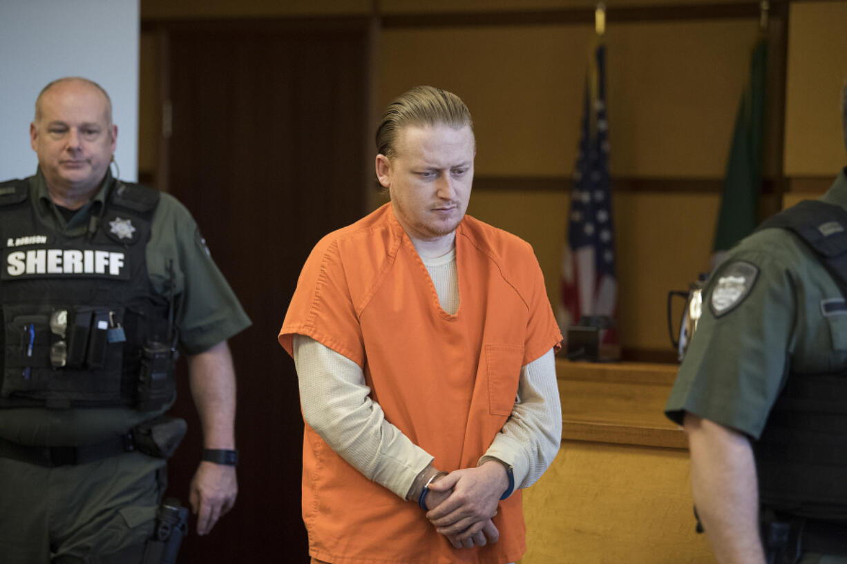 Kyle Holder, the father accused of nearly beating his 2-year-old daughter to death outside a Salmon Creek motel, is escorted into Clark County Superior Court on Thursday for a hearing to determine if he was legally insane at the time of the June 2016 attack.