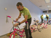 The 18th annual Vancouver Bike Build, sponsored in part by Waste Connections, was able to build 605 bicycles for needy children with the help of about 200 volunteers. Peter Van Tilburg, of Bike Clark County, puts the finishing touches on a bicycle for donation.