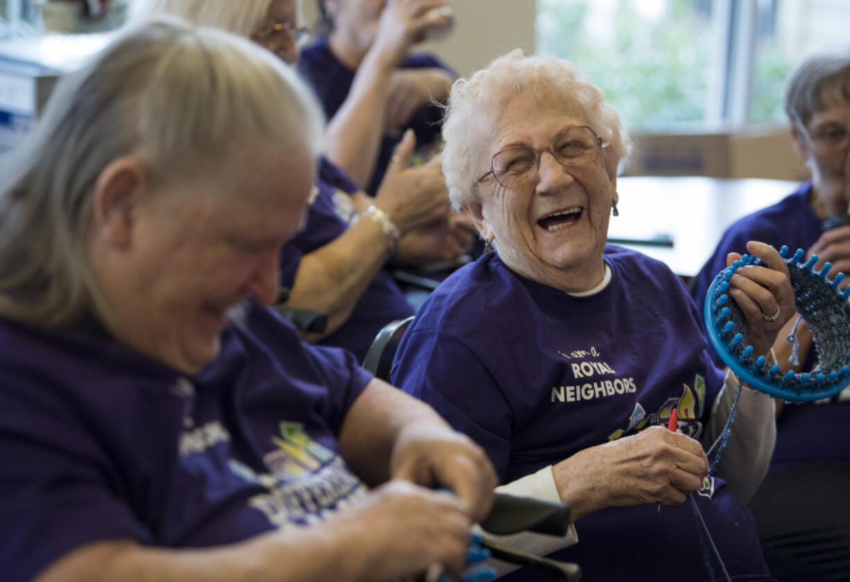 Judy Smith, left, and Marge Kleen, both of Vancouver, share a laugh as they work on their knitting projects during their weekly Knitty Gritty Heroes meet up at Vista Court, an income-restricted senior apartment complex in downtown Vancouver. The women have made more than 500 hats and 13 fleece blankets for local people experiencing homelessness.