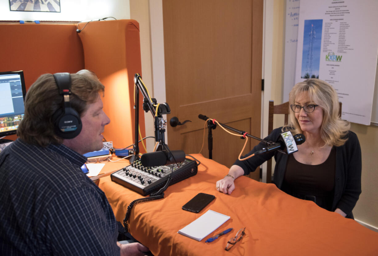 Mike Selig, left, and Susan Galaviz with KXRW-FM talk about the start of their radio station at Selig’s home recording studio.