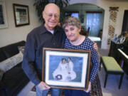 Les Burger, 77, and his wife, Julie Burger, 78, hold a portrait from their wedding in 1960 in their Vancouver home on Dec. 12. Julie, who was diagnosed with Alzheimer’s disease last year, can’t remember her wedding day.