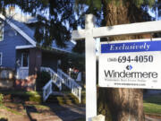 Wattle Tree Place is pictured behind a for-sale sign on East 16th Street. Recently, the entire street block containing six homes was sold.