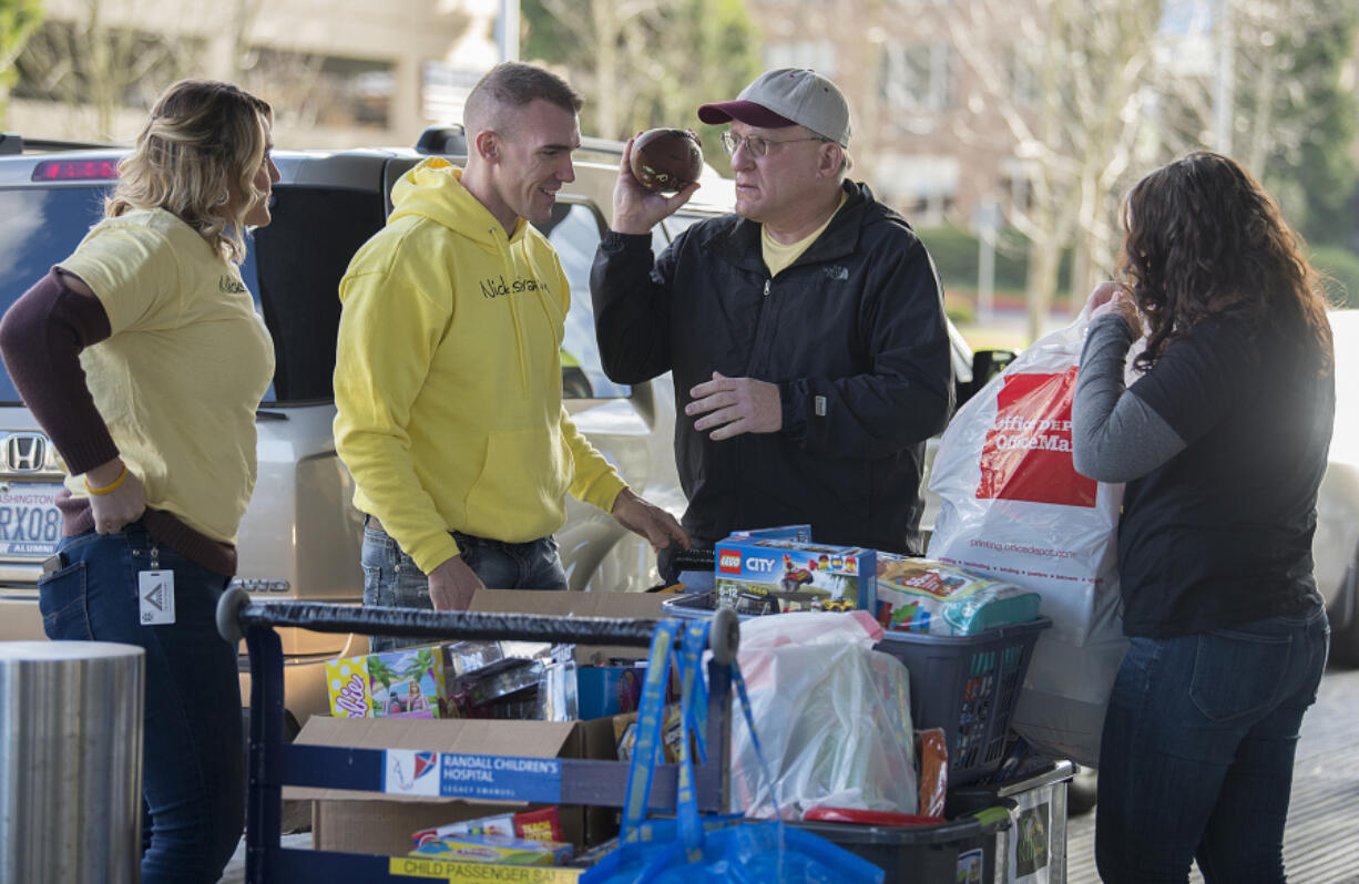 Natalie Zadak, aunt of Nick Zadak, from left, joins Nick’s dad, Robert, his grandfather, Chuck, and his mom, Katie, as they drop off toys in his honor at Randall Children’s Hospital.