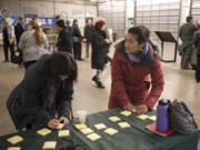 Ke Kukui Foundation resource council members Kapuanani Antonio-Claussen, left, and Kanani Yacapin, both of Portland, jot down ideas of how they would like to use a new cultural center during an open house.