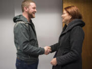 Clark Public Utilities employee Josh Vincent and Laurel Faught, both of Vancouver, meet in person for the first time at a Clark Public Utilities office in Vancouver on Friday. During a customer service call with Faught last March, Vincent noticed something sounded abnormal and called 911. Doctors later told Faught and her family that Vincent’s call likely saved her life.