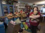 Vancouver resident Lucy Crouse, 10, is surrounded by some of the quilts and stuffed toys she made for Second Step Housing. Lucy, who has autism, has sewn 105 quilts and dozens of other gifts this year to donate to the Vancouver nonprofit.