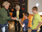 Washougal: Camas-Washougal Rotary Club members Molly Coston, from left, and Joyce Lindsay present dictionaries to Columbia River Gorge Elementary School third-graders Noah Migaki, Trenton Rogers and Joshua Homuth.