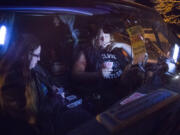 Shannon Medlin, 37, left, plays cribbage with her partner, who goes by his stage name, Thor Shreddington, 31, in their 1986 GMC Suburban. They’re taking part in the SafePark program, which permits people to park overnight in participating church parking lots. “I’m thankful to have a place like this,” Medlin said.