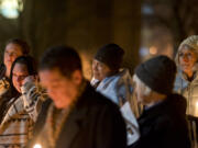 Deanna Huynh, center, of Vancouver, reacts when the name of her friend, Matt Solop, is read. Solop was one of 17 homeless people who died in Clark County in the past year.