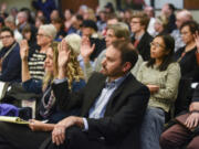 Andy Silver, executive director of the Council for the Homeless, swears an oath before testifying at a public hearing Tuesday on the proposed relocation of the day center for homeless people.